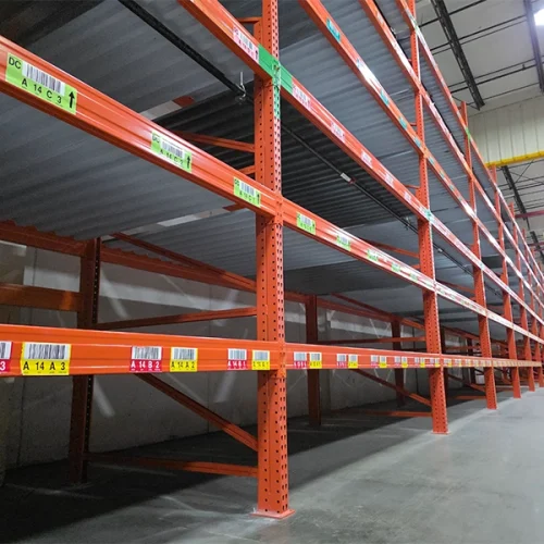 Empty industrial carpet storage racks featuring solid corrugated metal decking designed to support heavy flooring rolls.